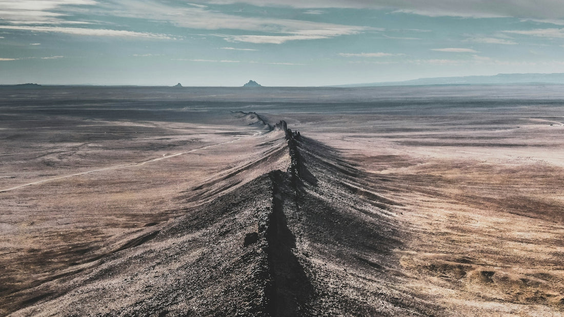 a dirt road in the middle of a desert