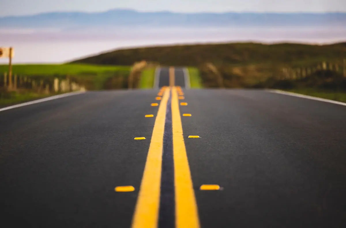 a long road with yellow lines on the side of it