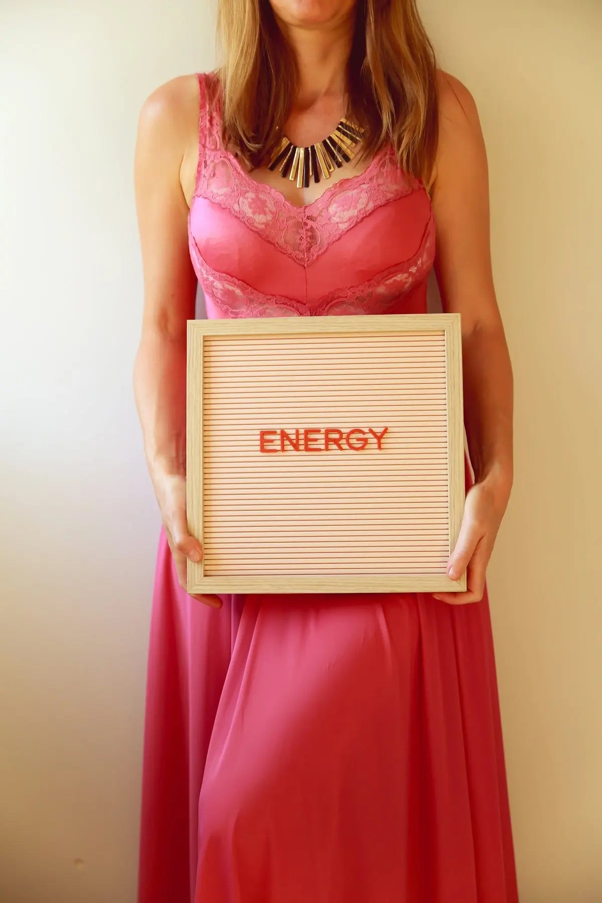 Woman holds a sign that says energy.