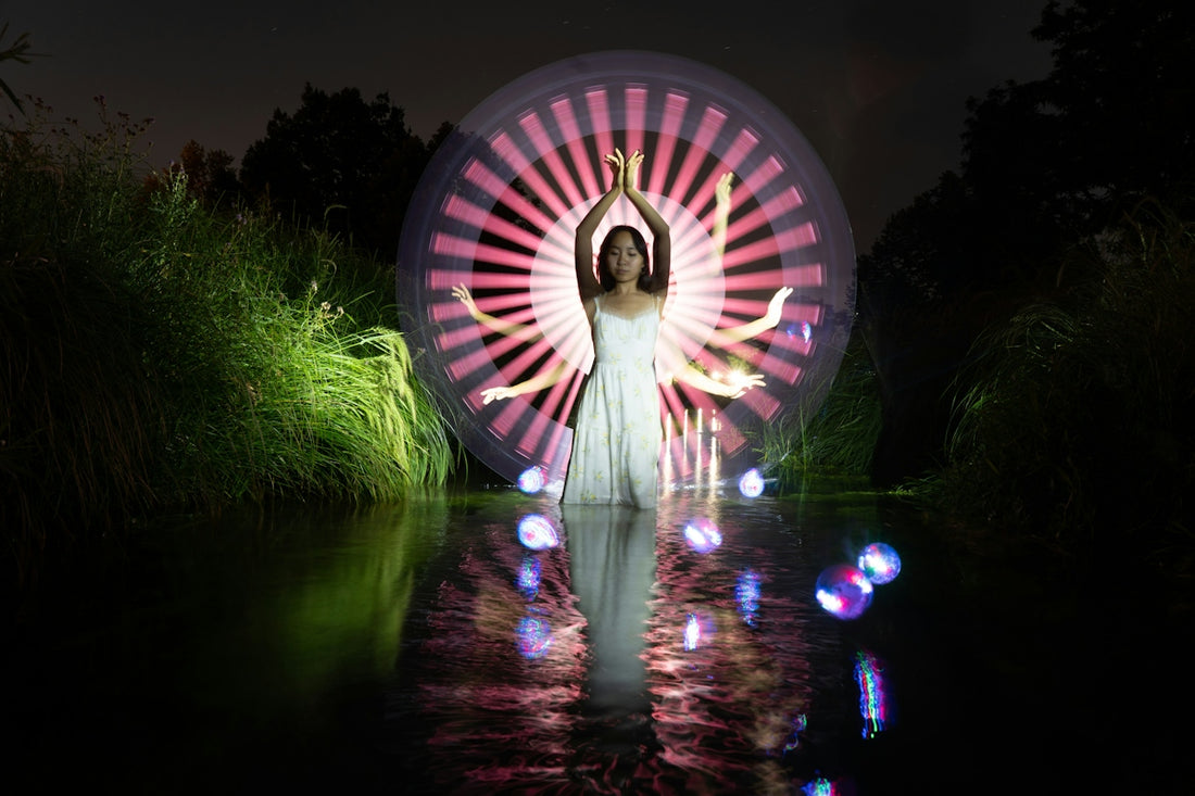 Woman poses with light circle in water